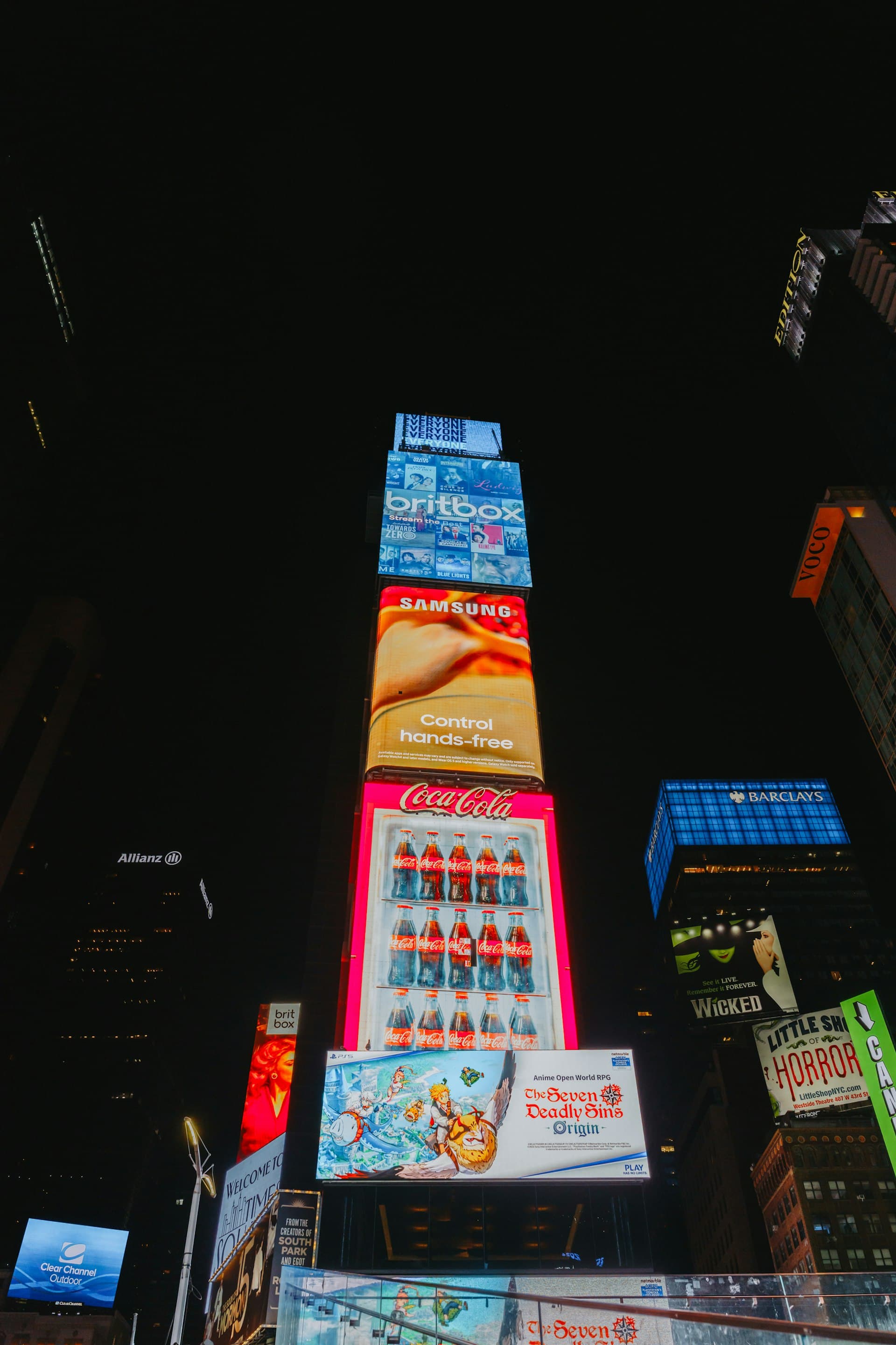 Digital billboards lighting up a city skyline at night